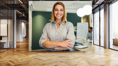 Female manager smiling happily in a boardroom Wall mural