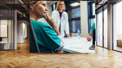 Female medical professional in staff meeting Wall mural