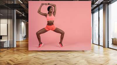 Fit woman doing stretching exercise Wall mural