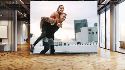 Fitness couple taking a break from training and having fun Wall mural