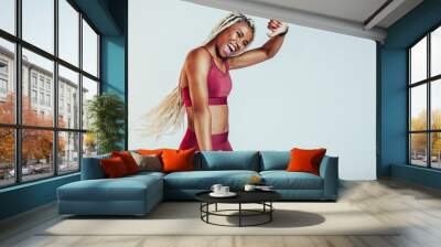 Fitness woman celebrating after workout Wall mural