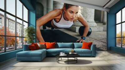 fitness woman doing push ups on a yoga mat Wall mural