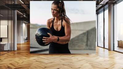 Fitness woman exercising with medicine ball Wall mural