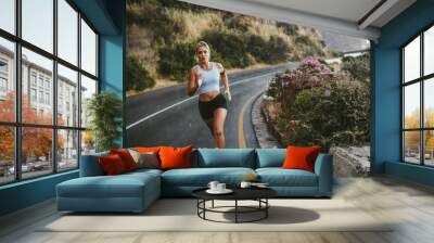 Fitness woman running on countryside highway Wall mural