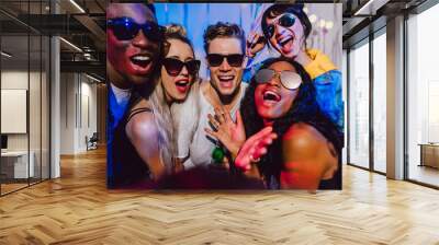 Friends enjoying at a house party Wall mural