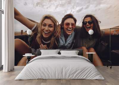 Friends having a great time on country road trip Wall mural