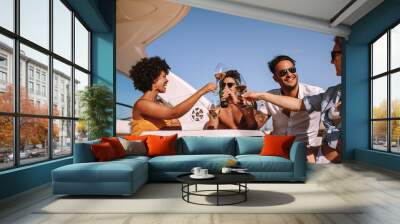 Friends partying on a boat with drinks Wall mural