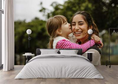 Girl kissing her nanny Wall mural