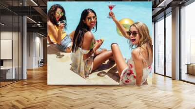 Girls hanging out by the pool with drinks Wall mural