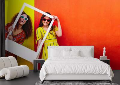 Girls looking through blank picture frame Wall mural