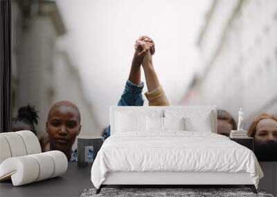 Group of activists with holding hands protesting Wall mural