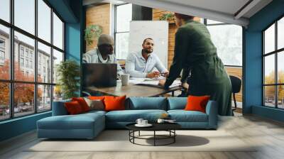 Group of business people having a meeting in a creative office Wall mural