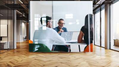 Group of businesspeople having a discussion in a meeting room Wall mural