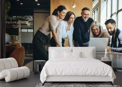 group of businesspeople using a laptop together Wall mural