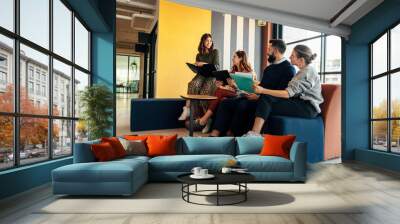 Group of businesspeople working in an office lobby Wall mural