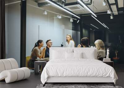 Group of colleagues having a meeting in a boardroom Wall mural