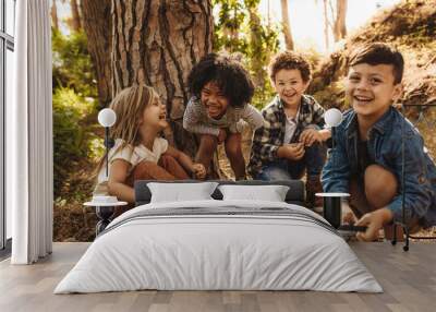 Group of cute kids playing in forest Wall mural