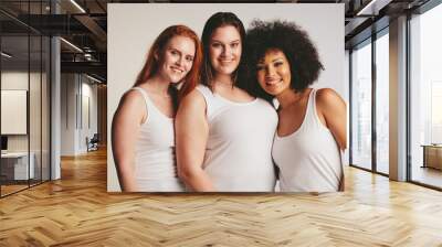 Group of different size women in white tank top Wall mural