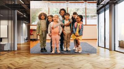 Group of elementary school students standing together in a classroom Wall mural