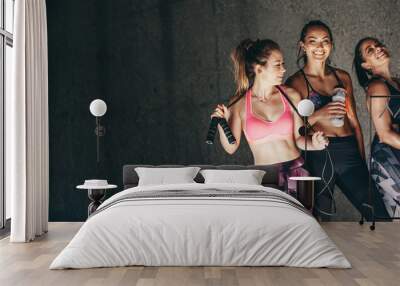 Group of female friends relaxing after workout Wall mural