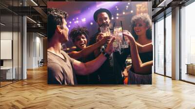 Group of friends at nightclub celebrating with drinks Wall mural