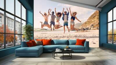 Group of friends on the beach having fun Wall mural