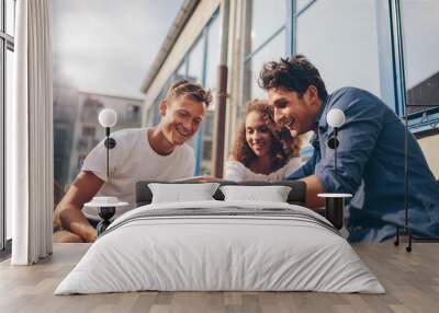 group of friends watching video on smartphone Wall mural