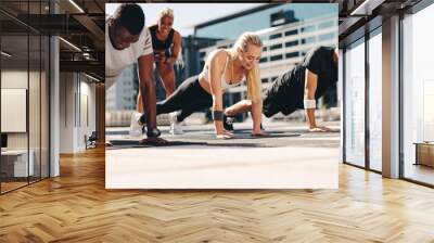 Group of people doing push ups outdoors Wall mural