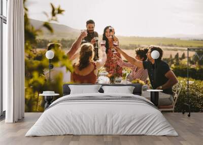 Group of people toasting wine during a dinner party Wall mural