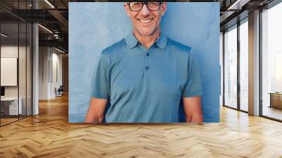 Handsome mature man smiling at camera Wall mural