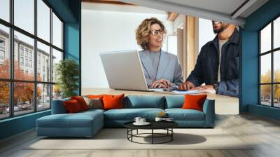 Happy business colleagues working together in an office Wall mural