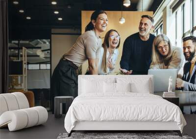 Happy businesspeople laughing in an office Wall mural