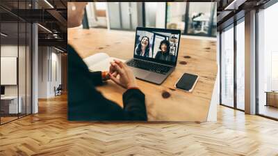 Happy businesswoman attending a video conference in an office Wall mural