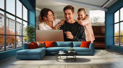 Happy family making video call Wall mural