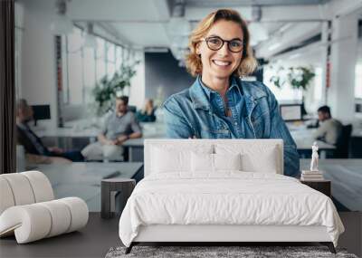 happy female designer standing in office Wall mural