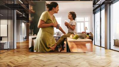 Happy mother and son smiling at each other in the kitchen Wall mural