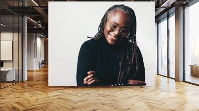 Happy professional woman smiling at the camera in a studio Wall mural