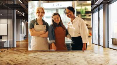 Happy retail workers smiling at the camera in a grocery store Wall mural