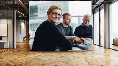 Happy senior businesswoman in boardroom meeting Wall mural