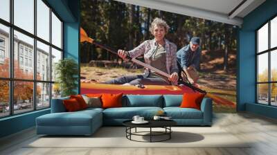 Happy senior woman in a kayak at the lake Wall mural