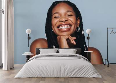 Happy woman with face piercings smiling at the camera Wall mural