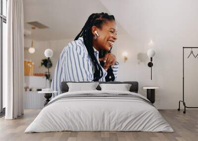 Happy young businesswoman having an online meeting with a client in a cafe Wall mural