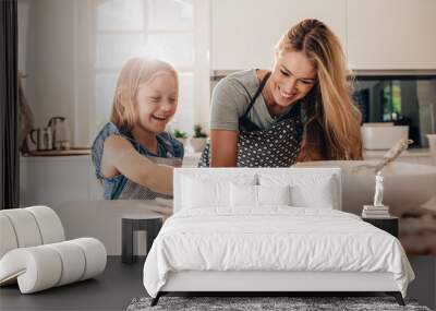 happy young girl with her mother making dough Wall mural