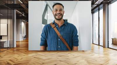 Happy young man in office corridor Wall mural