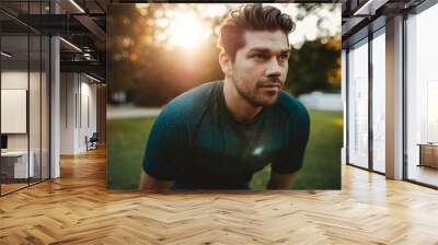 Healthy young man standing outdoors in park Wall mural