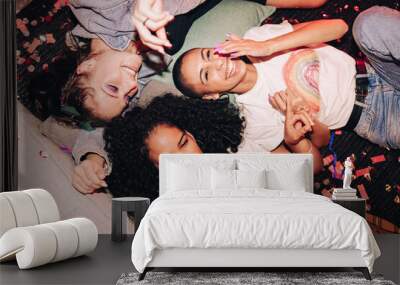 High angle view of happy friends lying on the floor at a party Wall mural