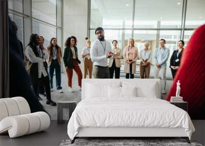 Instructor leading a team building exercise at a conference with diverse group Wall mural