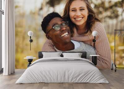 Interracial couple having fun outdoors Wall mural