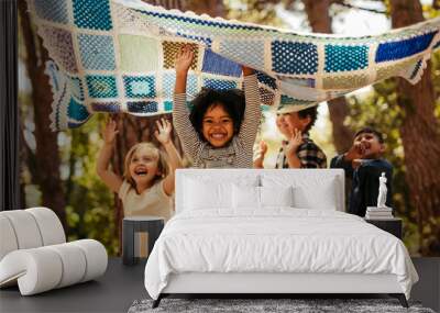 Kids having fun together in forest Wall mural