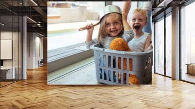 Kids rides in a laundry basket Wall mural